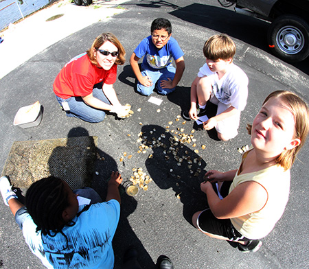 Children from Seatack Elementary talk to enviornmentalist Susan Conner from the Norfolk District about oysters.